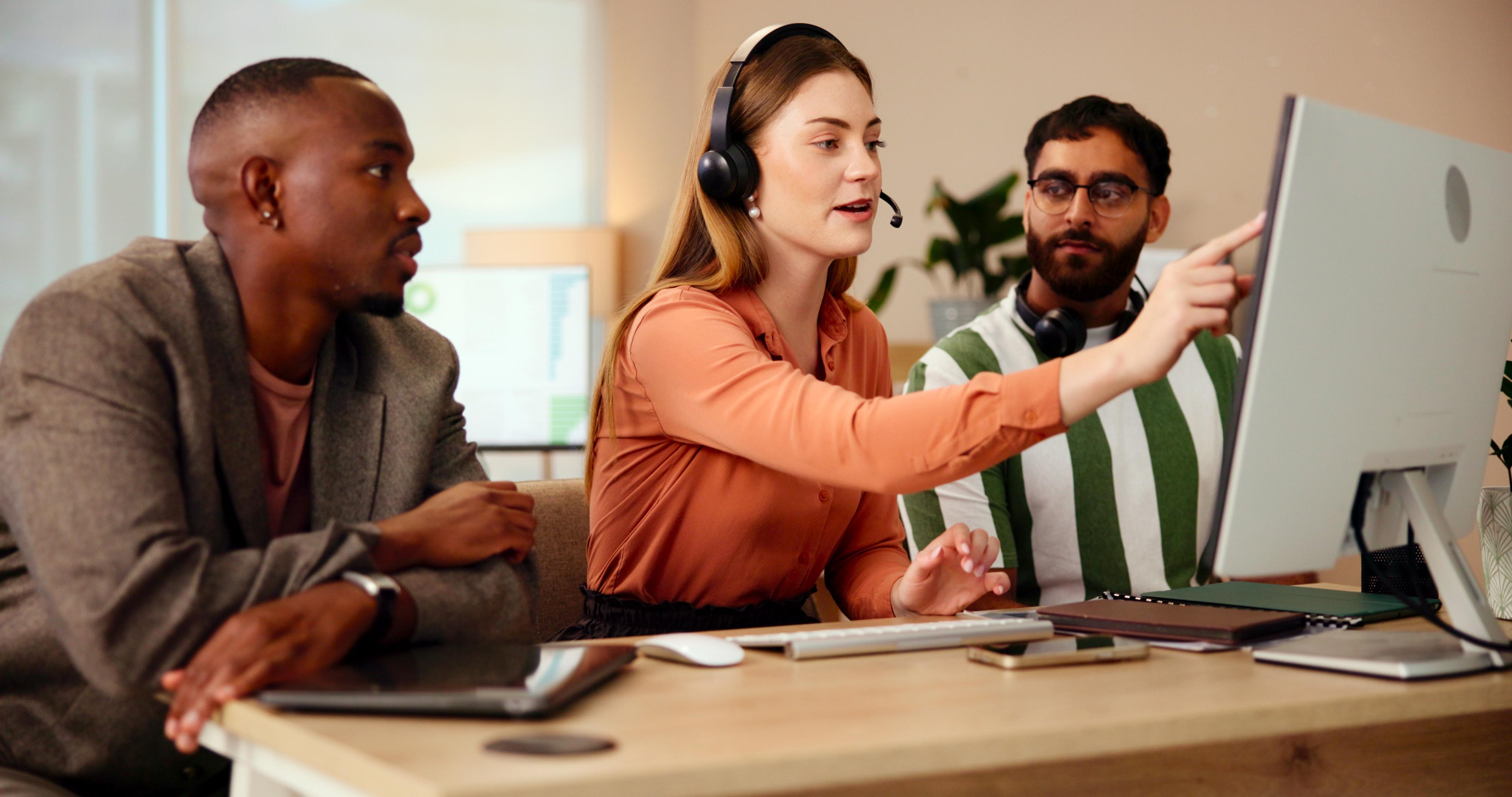 Customer training session with instructor and colleague at a workstation