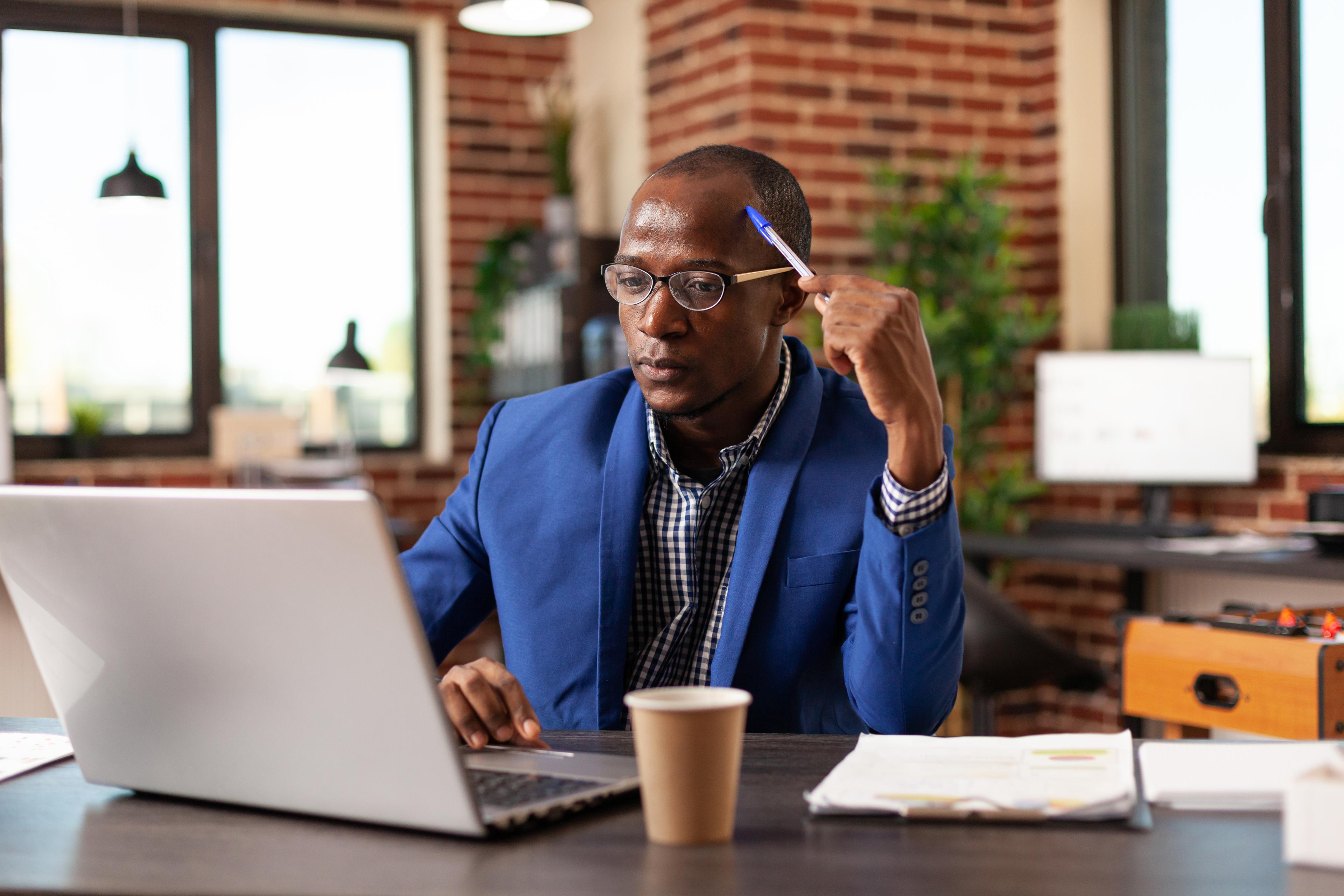 Professional working at a desk with a laptop